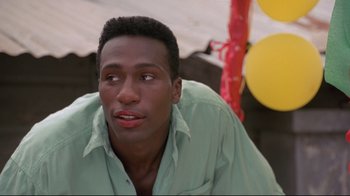 Movie still from “Cool Runnings” (1993), directed by Jon Turteltaub – A person wearing a green shirt; Close Up shot, Low angle