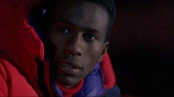 Movie still from “Cool Runnings” (1993), directed by Jon Turteltaub – A person wearing a jacket; Close Up shot, Low angle