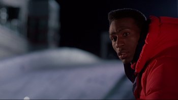 Movie still from “Cool Runnings” (1993), directed by Jon Turteltaub – A person wearing a jacket; Close Up shot, Low angle