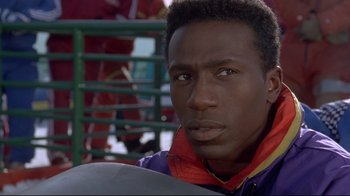 Movie still from “Cool Runnings” (1993), directed by Jon Turteltaub – A person wearing a jacket; Close Up shot, Low angle