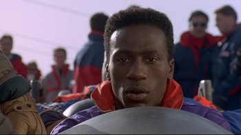 Movie still from “Cool Runnings” (1993), directed by Jon Turteltaub – A person wearing a jacket; Close Up shot, Low angle
