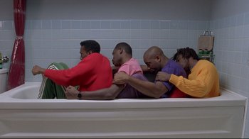 Movie still from “Cool Runnings” (1993), directed by Jon Turteltaub – A group of men sitting on top of a bathtub; Wide shot, Overhead angle