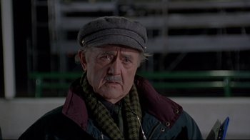 Movie still from “Cool Runnings” (1993), directed by Jon Turteltaub – An older man wearing a hat and a scarf; Close Up shot, Low angle