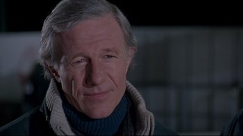 Movie still from “Cool Runnings” (1993), directed by Jon Turteltaub – An older man wearing a sweater and a scarf; Close Up shot, Low angle