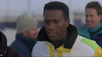 Movie still from “Cool Runnings” (1993), directed by Jon Turteltaub – A person wearing a jacket; Close Up shot, Low angle