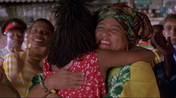 Movie still from “Cool Runnings” (1993), directed by Jon Turteltaub – Two women hugging each other while another woman watches; Close Up shot, Low angle