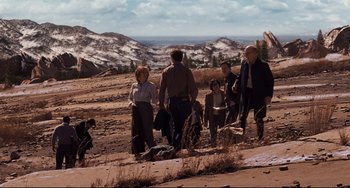 Movie still from “The Front Runner” (2018), directed by Jason Reitman – A group of people walking across a dirt field; Wide shot, High angle