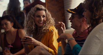 Movie still from “The Front Runner” (2018), directed by Jason Reitman – Two people sitting on a couch and one of them is holding a cell phone in her hand; Medium shot, Over the shoulder angle