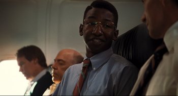 Movie still from “The Front Runner” (2018), directed by Jason Reitman – A man in a tie and glasses is sitting on a plane; Close Up shot, Low angle
