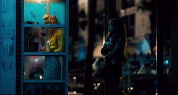 Movie still from “The Front Runner” (2018), directed by Jason Reitman – A woman standing in front of a window at night; Wide shot, Over the shoulder angle