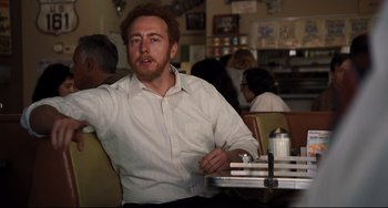 Movie still from “The Front Runner” (2018), directed by Jason Reitman – A man sitting at a table in a restaurant; Medium shot, Over the shoulder angle