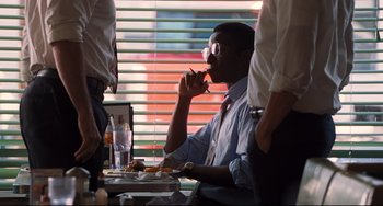 Movie still from “The Front Runner” (2018), directed by Jason Reitman – A man sitting at a table with a plate of food in front of him; Medium shot, Over the shoulder angle