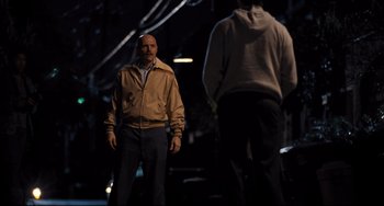 Movie still from “The Front Runner” (2018), directed by Jason Reitman – A man standing in front of another man in the dark; Medium shot, Over the shoulder angle