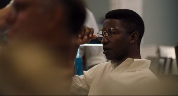 Movie still from “The Front Runner” (2018), directed by Jason Reitman – A man wearing glasses and a white shirt is looking at his reflection in the mirror; Close Up shot, Over the shoulder angle