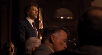 Movie still from “The Front Runner” (2018), directed by Jason Reitman – A man standing in front of a microphone; Medium shot, Over the shoulder angle