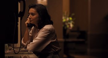 Movie still from “The Front Runner” (2018), directed by Jason Reitman – A woman sitting at a table talking on the phone; Medium shot, High angle