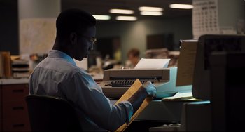 Movie still from “The Front Runner” (2018), directed by Jason Reitman – A man sitting in front of an open envelope; Medium shot, Low angle
