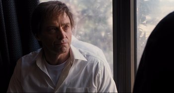 Movie still from “The Front Runner” (2018), directed by Jason Reitman – A person wearing a white shirt near a window; Close Up shot, Low angle
