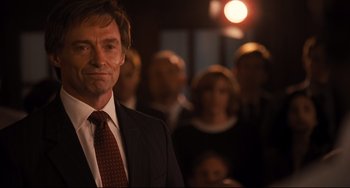 Movie still from “The Front Runner” (2018), directed by Jason Reitman – A man in a suit standing in front of a group of people; Close Up shot, Over the shoulder angle