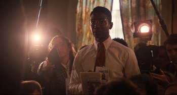 Movie still from “The Front Runner” (2018), directed by Jason Reitman – A man in a white dress shirt and tie holding papers; Medium shot, Over the shoulder angle