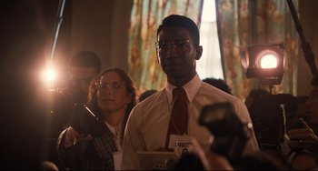 Movie still from “The Front Runner” (2018), directed by Jason Reitman – A man in a white dress shirt and red neck tie; Medium shot, Over the shoulder angle