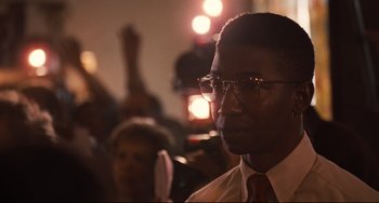 Movie still from “The Front Runner” (2018), directed by Jason Reitman – A person wearing glasses and a tie; Close Up shot, Over the shoulder angle