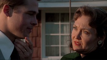 Movie still from “Cool World” (1992), directed by Ralph Bakshi – An older woman talking to a younger man outside; Close Up shot, Over the shoulder angle