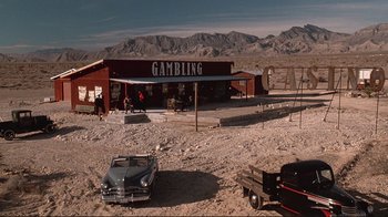Movie still from “Cool World” (1992), directed by Ralph Bakshi – An old car is parked in front of a gambling establishment; Extreme Wide shot, High angle