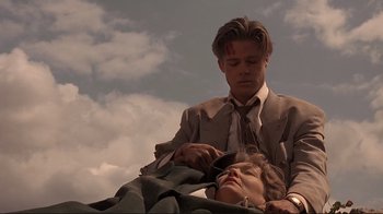 Movie still from “Cool World” (1992), directed by Ralph Bakshi – A man and a woman are laying on the ground; Medium shot, Low angle