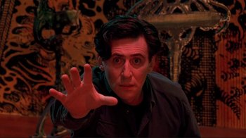 Movie still from “Cool World” (1992), directed by Ralph Bakshi – A man with his hand up in the air in front of him; Medium shot, Low angle