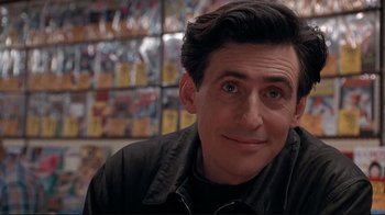 Movie still from “Cool World” (1992), directed by Ralph Bakshi – A person wearing a black jacket; Close Up shot, Over the shoulder angle