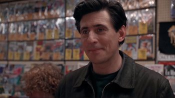 Movie still from “Cool World” (1992), directed by Ralph Bakshi – A person wearing a jacket in a room; Close Up shot, Over the shoulder angle