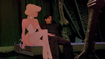 Movie still from “Cool World” (1992), directed by Ralph Bakshi – A man sitting next to an animated woman; Medium shot, Low angle