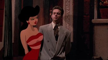 Movie still from “Cool World” (1992), directed by Ralph Bakshi – A man in a suit standing next to a woman in a red dress; Medium shot, Low angle
