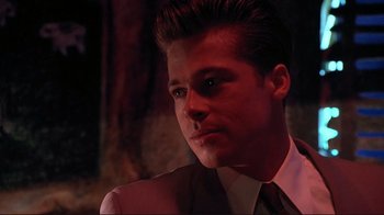 Movie still from “Cool World” (1992), directed by Ralph Bakshi – A man in a white shirt and a red tie; Close Up shot, Over the shoulder angle