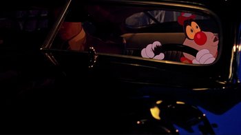 Movie still from “Cool World” (1992), directed by Ralph Bakshi – A cartoon of mickey mouse and minnie mouse in a car; Close Up shot, Over the shoulder angle