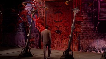 Movie still from “Cool World” (1992), directed by Ralph Bakshi – A man standing in front of a red wall; Wide shot, High angle