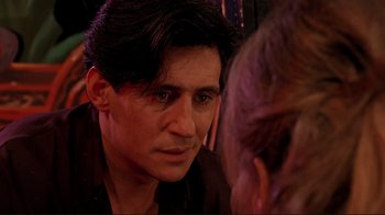 Movie still from “Cool World” (1992), directed by Ralph Bakshi – A person looking at a mirror; Close Up shot, Over the shoulder angle