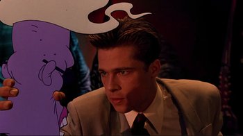 Movie still from “Cool World” (1992), directed by Ralph Bakshi – A man in a suit and tie next to cartoon characters; Close Up shot, Low angle