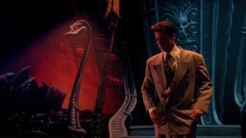 Movie still from “Cool World” (1992), directed by Ralph Bakshi – A man standing in front of a painting of a swan; Medium shot, Low angle