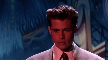 Movie still from “Cool World” (1992), directed by Ralph Bakshi – A man in a white suit and a red neck tie; Close Up shot, Low angle
