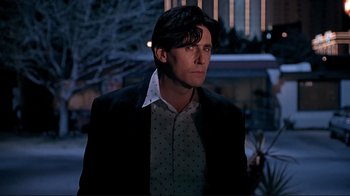 Movie still from “Cool World” (1992), directed by Ralph Bakshi – A man in a black jacket and a white polka dot shirt; Medium shot, Low angle