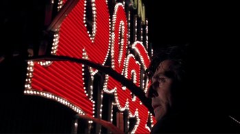 Movie still from “Cool World” (1992), directed by Ralph Bakshi – A man standing in front of a neon sign; Close Up shot, Low angle