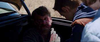 Movie still from “Cop Car” (2015), directed by Jon Watts – A man in a car with blood all over his face; Close Up shot, Over the shoulder angle