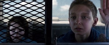 Movie still from “Cop Car” (2015), directed by Jon Watts – A young boy looking out of a car window; Close Up shot, Over the shoulder angle