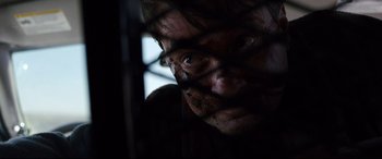 Movie still from “Cop Car” (2015), directed by Jon Watts – A person looking through a fence; Close Up shot, Low angle