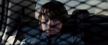 Movie still from “Cop Car” (2015), directed by Jon Watts – A young boy sitting in the back of a car; Close Up shot, Low angle