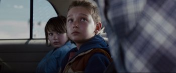 Movie still from “Cop Car” (2015), directed by Jon Watts – Two young boys sitting in a car looking up; Close Up shot, Over the shoulder angle