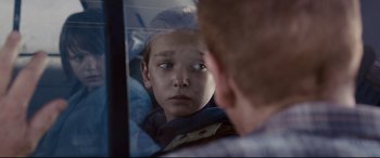 Movie still from “Cop Car” (2015), directed by Jon Watts – A boy looking at himself in the mirror; Close Up shot, Over the shoulder angle