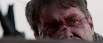 Movie still from “Cop Car” (2015), directed by Jon Watts – A man's face with blood on it; Extreme Close Up shot, Low angle